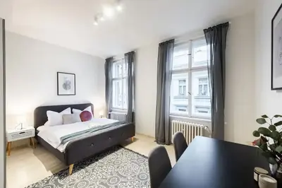 a bedroom with a bed and a dining room table at Welcoming Studio in Historic Prague in Prague