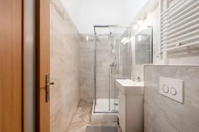 a bathroom with a shower and a toilet and a sink at Peaceful Chic Studio in Central Prague in Prague