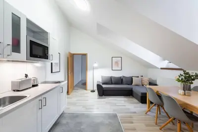 a kitchen and living room with a couch and a table at Elegant 4-Guest Retreat near Old Town in Prague
