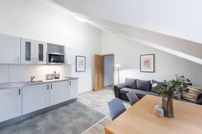 a kitchen and living room with a couch and a table at Elegant 4-Guest Retreat near Old Town in Prague