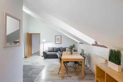 a living room with a table and a couch at Elegant 4-Guest Retreat near Old Town in Prague