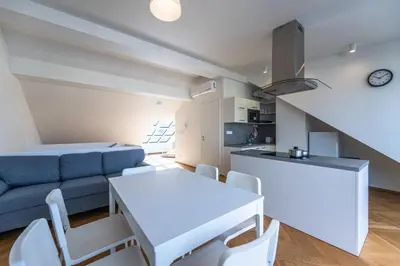 a living room with a couch and a table at Apartments Seifertova in Prague