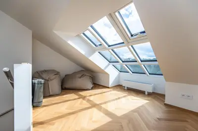 a attic room with skylights and wooden floors at Apartments Seifertova in Prague