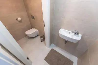 a bathroom with a sink and a toilet at Apartments Seifertova in Prague