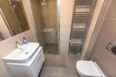 a bathroom with a sink and a shower and a toilet at Apartments Seifertova in Prague