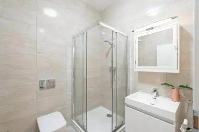 a bathroom with a shower and a toilet and a sink at Tranquil Prague Studio Gem in Prague