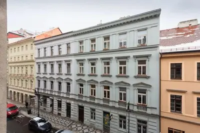 a large white building with cars parked in front of it at Tranquil Prague Studio Gem in Prague