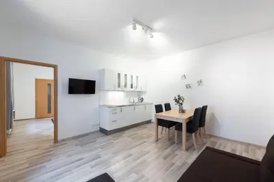 a kitchen and dining room with a table and chairs at Charming Spacious Apartment in Central Prague in Prague