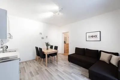 a living room with a black couch and a table at Charming Spacious Apartment in Central Prague in Prague