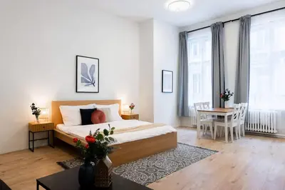 a bedroom with a large bed and a table with a table sidx sidx at Elegant Spacious Old Town Studio in Prague