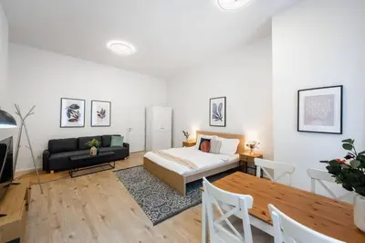 a bedroom with a bed and a couch and a table at Elegant Spacious Old Town Studio in Prague