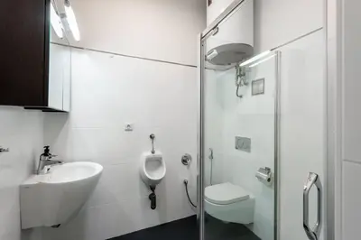 a bathroom with a sink and a toilet and a urinal at Elegant Spacious Old Town Studio in Prague