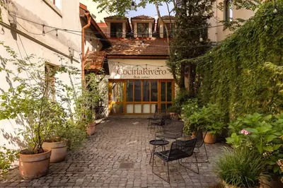 a patio with chairs in front of a building at Metropolitan Prague Apt with Amenities in Prague