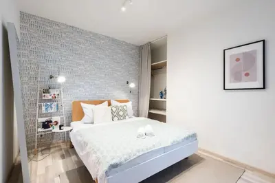 a bedroom with a white bed and a brick wall at Neat Cozy Old Town Retreat w Queen Bed in Prague