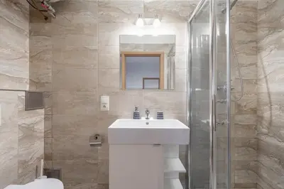 a bathroom with a sink and a shower at Neat Cozy Old Town Retreat w Queen Bed in Prague