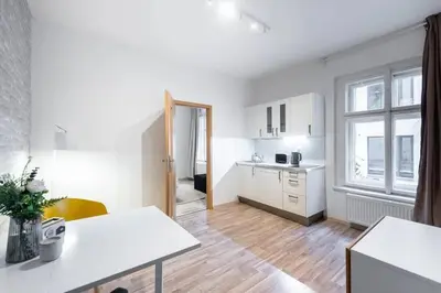 a white kitchen with a table and a window at Neat Cozy Old Town Retreat w Queen Bed in Prague