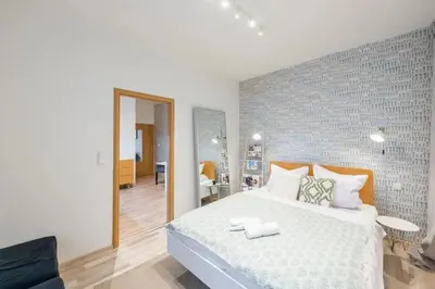 a bedroom with a large white bed with a mirror at Neat Cozy Old Town Retreat w Queen Bed in Prague