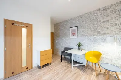 a room with a desk and a yellow chair at Neat Cozy Old Town Retreat w Queen Bed in Prague