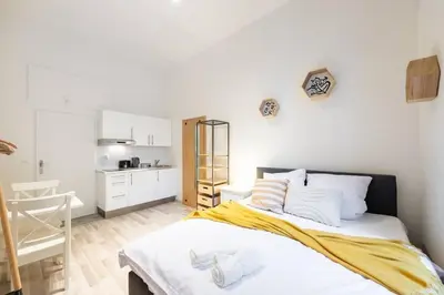 a bedroom with a bed with a yellow blanket on it at Romantic Old Town Studio in Prague