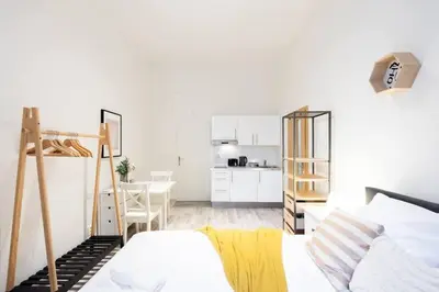 a bedroom with a bunk bed and a kitchen at Romantic Old Town Studio in Prague