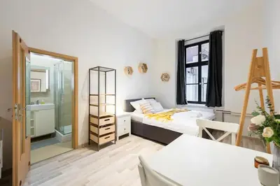 a small bedroom with a bed and a bathroom at Romantic Old Town Studio in Prague