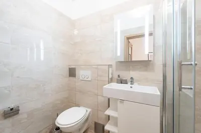 a white bathroom with a toilet and a sink at Romantic Old Town Studio in Prague