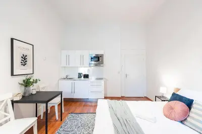 a living room with a couch and a table at Sunny Old Town Studio in Prague