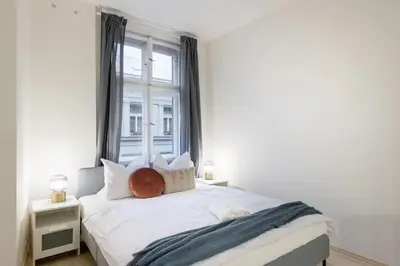 a bedroom with a white bed with a window at Vast Central Old Town Studio For 3 in Prague