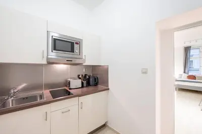 a kitchen with a sink and a microwave at Vast Central Old Town Studio For 3 in Prague