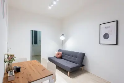 a living room with a couch and a table at Vast Central Old Town Studio For 3 in Prague