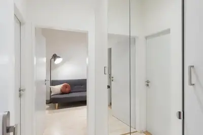 a glass door leading into a bedroom with a couch at Vast Central Old Town Studio For 3 in Prague