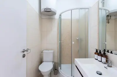 a bathroom with a toilet and a shower and a sink at Vibrant Old Town Studio in Prague