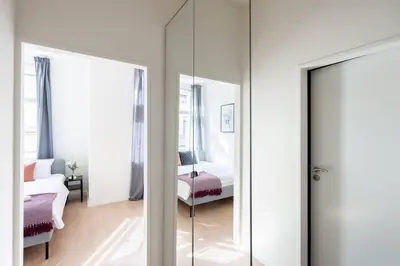 a room with a mirror and a bed and a bedroom at Vibrant Old Town Studio in Prague