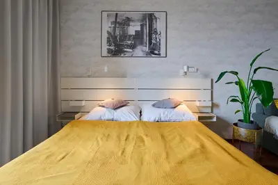 a bedroom with a tv on the wall and a bed at High-Sky O2 arena Apartment with garage parking and AC in Prague