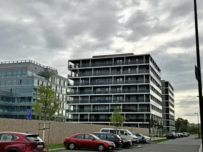 a parking lot with cars parked in front of a building at New studio, King bed, Free parking, Terrace in Prague