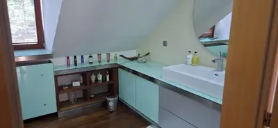 a bathroom with a sink and a counter with a mirror at Rodinný dům Praha 8, Kobylisy in Prague