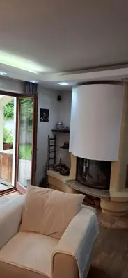a living room with a couch and a fireplace at Rodinný dům Praha 8, Kobylisy in Prague