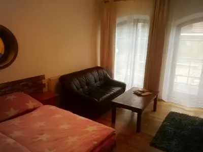 a living room with a leather chair and a coffee table at Villa Barrandov pokoj 3 in Prague