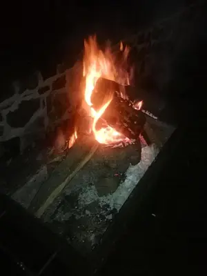 a fire in a brick oven at night at Villa Barrandov pokoj 3 in Prague