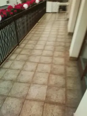 a tile floor in a balcony with flowers at Villa Barrandov pokoj 3 in Prague