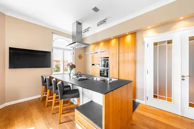 a kitchen with a island with black counter tops at Cozy place with wonderful view in Prague