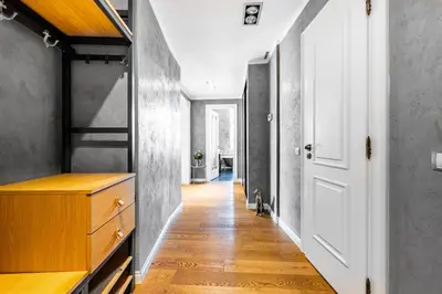 a hallway with a white door and a wooden floor at Cozy place with wonderful view in Prague