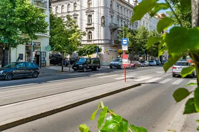 a busy city street with cars parked on the road at Cozy place with wonderful view in Prague