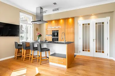a kitchen with a counter and a island in a room at Cozy place with wonderful view in Prague