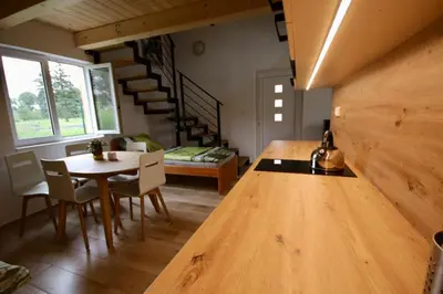 a kitchen and dining room with a table and chairs at Apartmány Kanoistika Roudnice in Vědomice