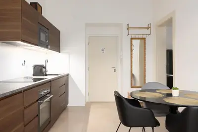a kitchen and dining room with a table and chairs at Quiet apartment in the city center near the metro with with balcony and parking in Prague