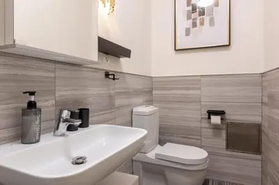 a bathroom with a white sink and a toilet at Quiet apartment in the city center near the metro with with balcony and parking in Prague