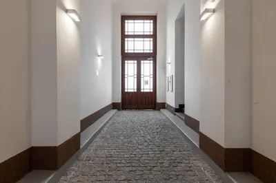 an empty hallway with a door and a stone floor at Quiet apartment in the city center near the metro with with balcony and parking in Prague