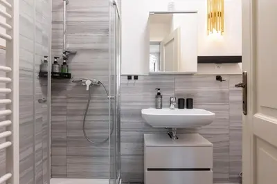 a bathroom with a white sink and a shower at Quiet apartment in the city center near the metro with with balcony and parking in Prague