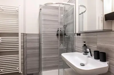 a bathroom with a sink and a shower at Quiet apartment in the city center near the metro with with balcony and parking in Prague